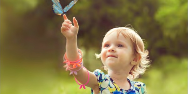 young girl catching a butterfly